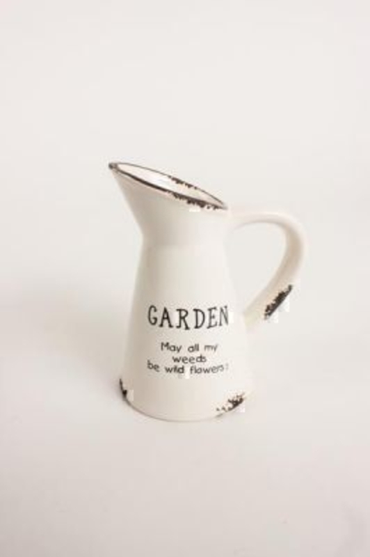 Mini Garden Ceramic Jug by Heaven Sends. Rustic look jug made to look like weathered tin although it is actually ceramic so it is water tight for using as a vase. On the front it has the words 'Garden may all my weeds be wild flowers' Size 13x10x6cm